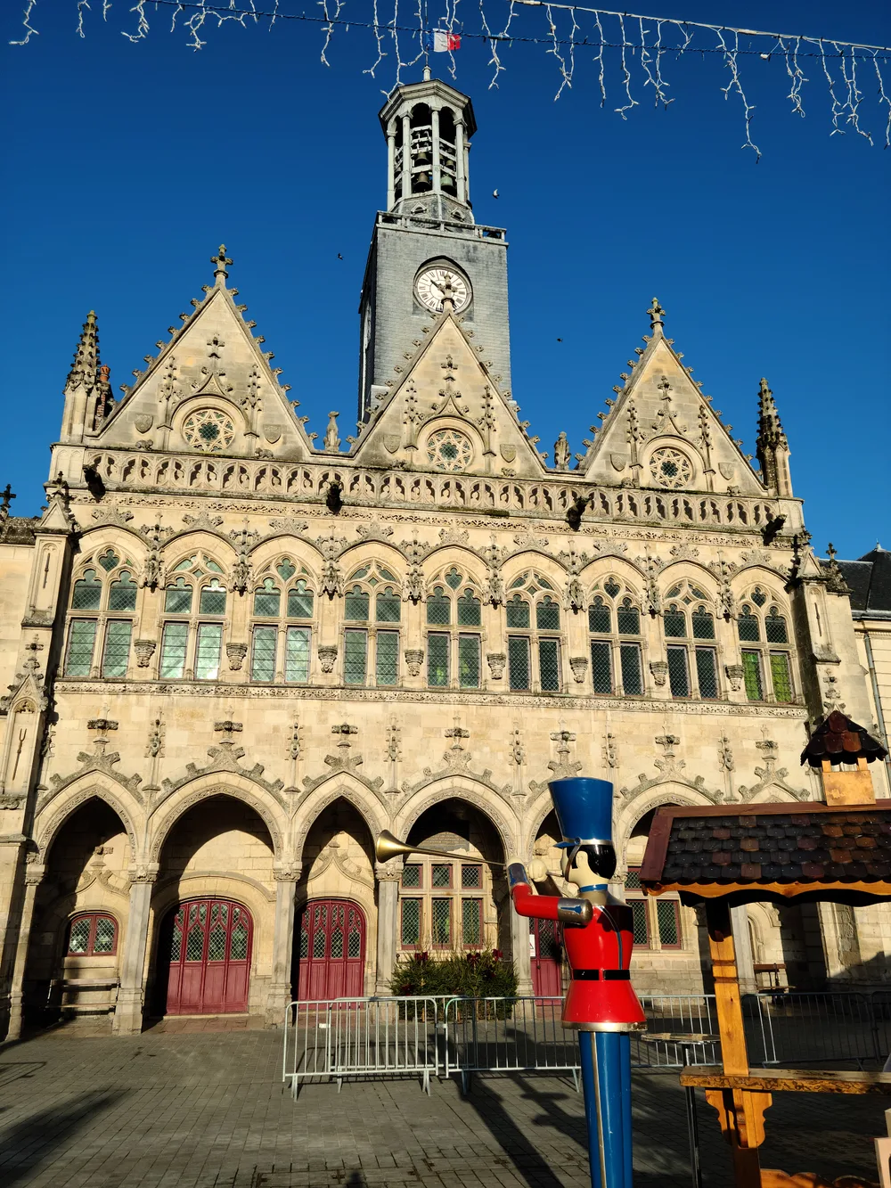 Gothic facade of the Basilique de Saint-Quentin adorned with Christmas decorations, northern France