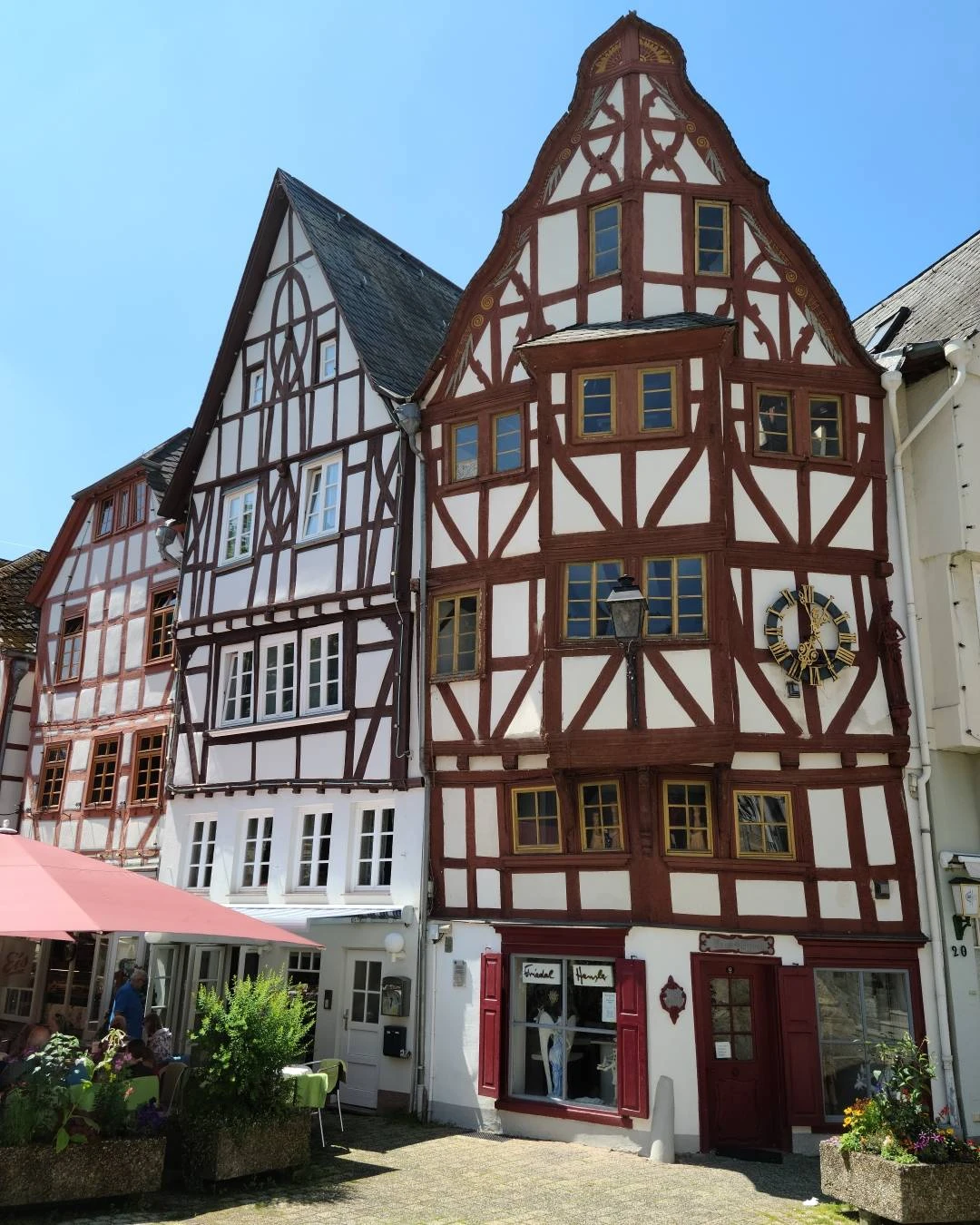 Colorful half-timbered houses lining a sunny street in Limburg an der Lahn, Germany